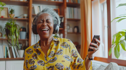 Cheerful and energetic mature woman dancing at home with wireless headphones and smartphone