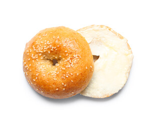 Tasty bagel with butter on white background