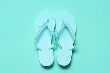Beach flip-flops on turquoise background