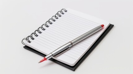 Silver pen is lying on a blank white spiral notebook with a black cover for business planning