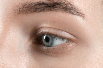 Obraz premium Woman with beautiful blue eyes, macro photo