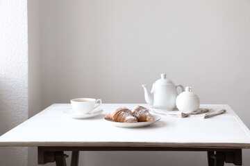 Croissants and tea on table in studio. Professional food photography