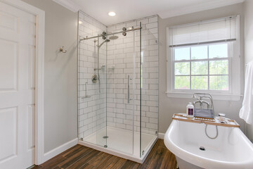 Modern Bathroom With Glass Shower And Freestanding Tub In Bright Setting - obrazy, fototapety, plakaty