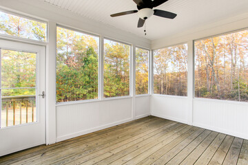 Autumn Covered Porch With A Fan Overlooking A Lush Garden And Greenery.