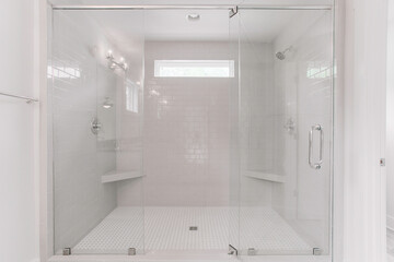 Large Glass-Enclosed White Shower With Clean Lines And Modern Fixtures