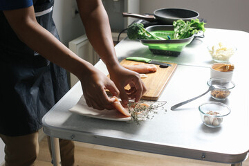 Man Preparing Ingredients Chicken Steak With Salad At Kitchen