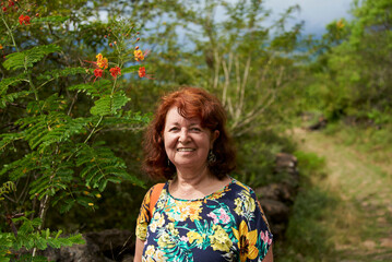 Portrait of an active mature hispanic woman with a positive attitude who smiles happy looking at...