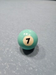 Pool balls on gray table sport game set known as eight ball pool. Number seven.