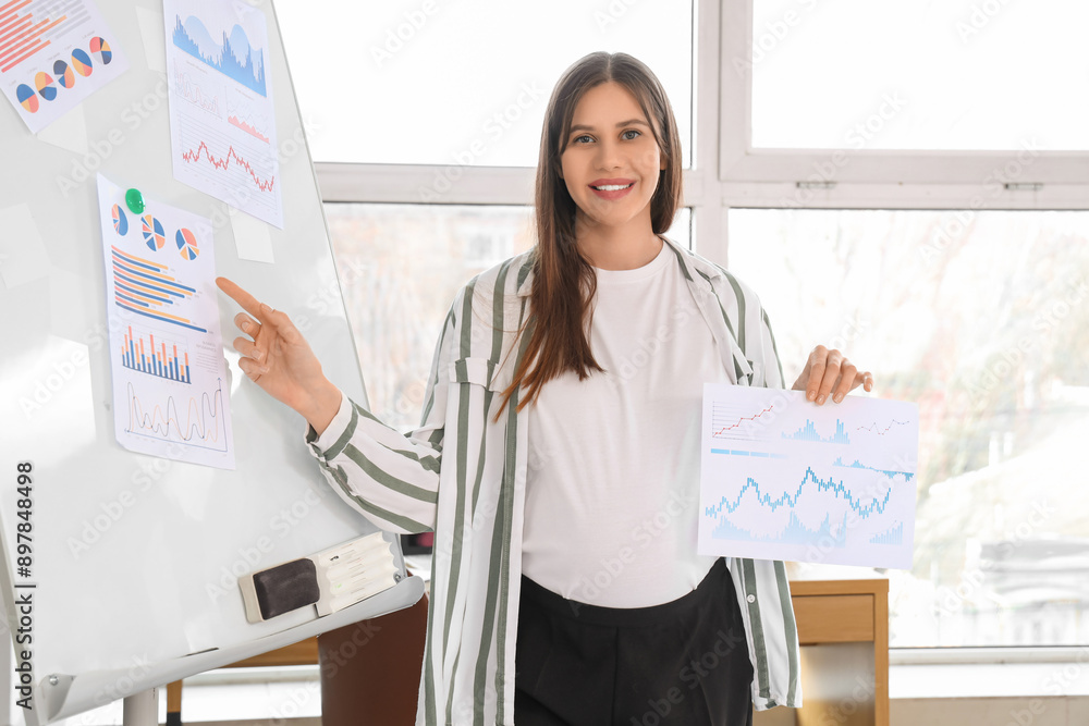 Sticker beautiful pregnant businesswoman working with diagrams in office