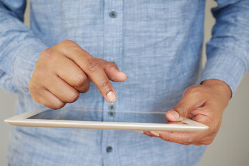  man hand using digital tablet on black background 