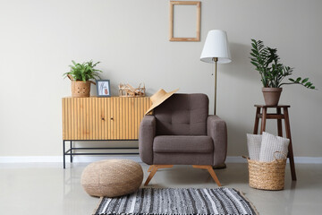 Comfortable armchair in stylish interior of living room