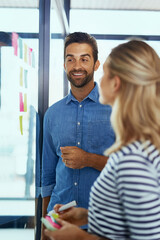 Business, people and sticky notes on glass for project ideas, planning and schedule management of startup. Woman, man and paper for brainstorming, support goals or productivity solution in office