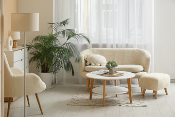Interior of living room with cozy sofa, armchair and coffee table