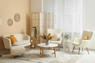 Fototapeta premium Comfortable sofa, armchairs and coffee table in interior of living room