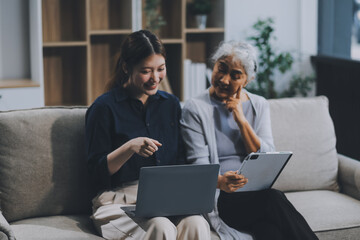 Asian elderly women and friend using social media and living room. Video streaming, happiness and conversation at a house with old people together