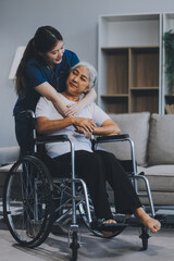 Asian physiotherapist helping elderly woman patient stretching arm during exercise correct with dumbbell in hand during training hand with patient Back problems in garden. Nursing home hospital