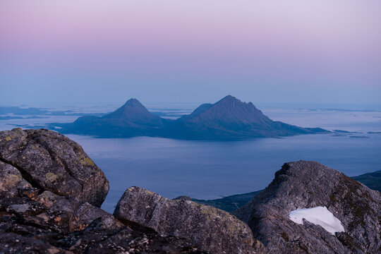 Midnight sun sunset view over Tomma island, in the archipelagio of Northern Norway, Helgeland. Smaltind, Breitind and Tortenviktind in the foreground.