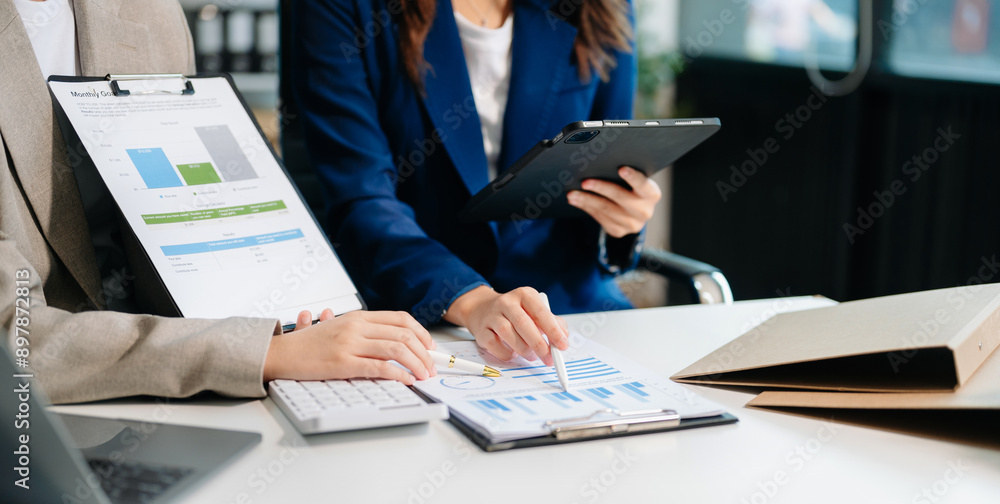Poster business documents on office table with smart phone and calculator digital tablet and graph business