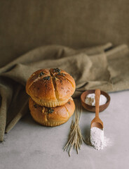 2 garlic bread stacked on a plate with wheat and flour