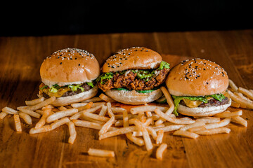 three hamburgers and a side of french fries