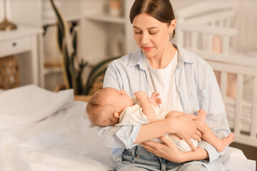 Obraz premium Mother with her little baby sitting in bedroom