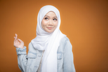 Portrait of a beautiful Malaysian and Indonesian Muslim young women wearing modern and casual wear with hijab on isolated studio background. Modern hijab fashion and beauty concept