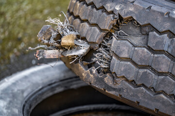 Big rig semi truck tire with large tread damaged during operation cannot be repaired due to damage of the cord structure
