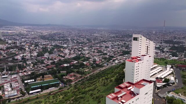 Aerial view of the city of Quer&eacute;taro capital during a cloudy day, houses and buildings of a town
