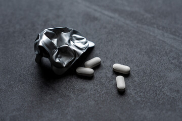 white pills on black background