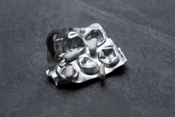 white pills on black background