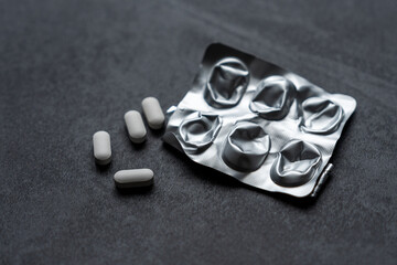 white pills on black background