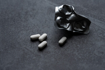 white pills on black background