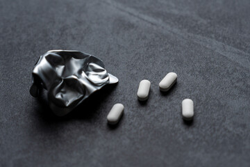 white pills on black background