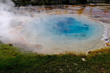 beautiful blue hot spring called Silex Spring with steam, at Lower Geyser Basin, Yellowstone National Park, USA