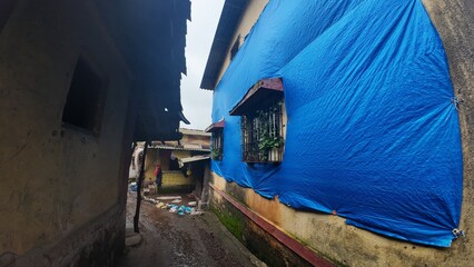  A rural village in Maharashtra during the rainy season with small huts and houses.
