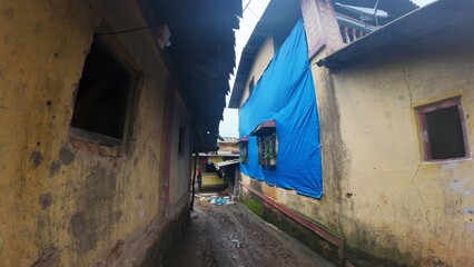  A rural village in Maharashtra during the rainy season with small huts and houses.