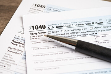 Tax Return form 1040 with pen, U.S. Individual Income.