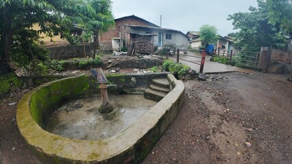  A rural village in Maharashtra during the rainy season with small huts and houses.