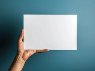 Hand holding a blank whiteboard, teaching and presentation concept