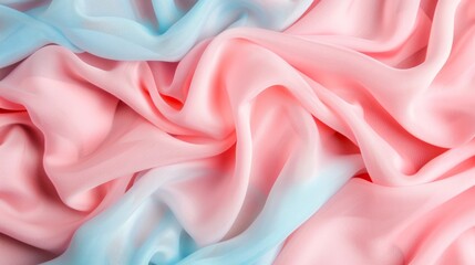 Obraz premium Soft silk fabric in pastel tones of pink and blue, creating a smooth and flowing texture ideal for elegant designs.