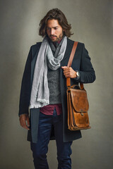 Thinking, suit and man with leather bag in studio isolated on gray background. Fashion, retro and...