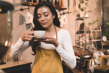 portrait of waitress handing and sip a coffee and present coffee with smiling. the happiness woman in coffee shop on waitress uniform and service customer.