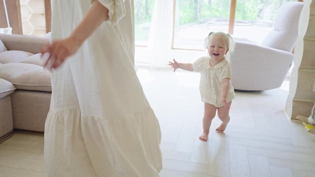 Mother and Daughter Play in White Living Room