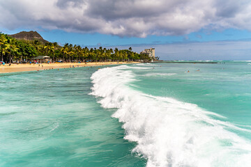 Fototapeta premium View of Waikiki Beach with people relaxing.