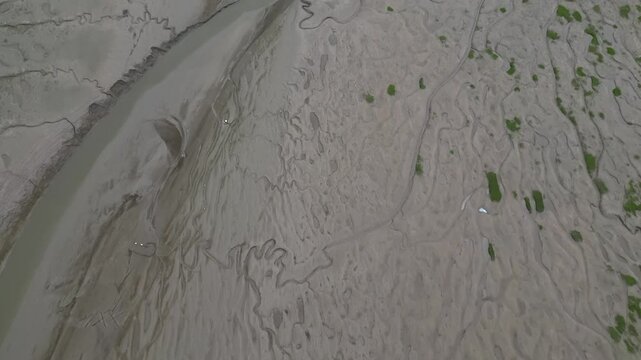 Flying over the sandy lifeless beach of the Heswall coastline