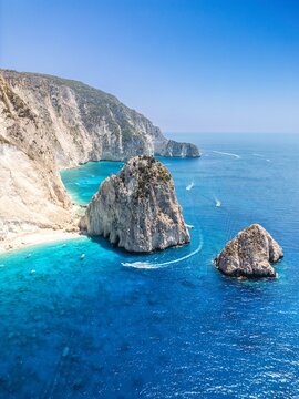 The drone aerial view of Mizithres beach, Zakynthos Island, Greece. The two conical huge rocks, that bounce from the crystal blue waters in Keri, are called the Small and Big Mitzithra.