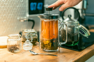 Piston kettle, preparing tea. Pressure machine. Kitchen interior equipment. Spices jar.