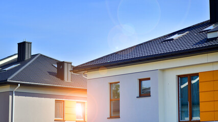 Terraced residential homes with modern facade in newly developed housing estate. The real estate market in the suburbs. New terraced houses in a new development area.