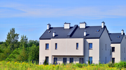 Terraced residential homes with modern facade in newly developed housing estate. The real estate...