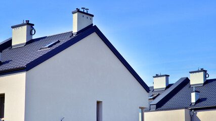 Terraced residential homes with modern facade in newly developed housing estate. The real estate market in the suburbs. New terraced houses in a new development area.